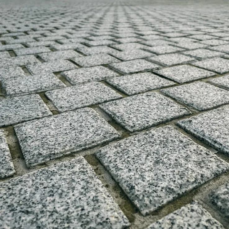 Stone paving surface suitable for developer arrival circulation and accessible walkways.