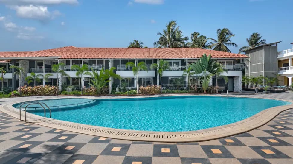 Resort-style pool deck with landscaped frontage and palm planting for an upscale community ambience.